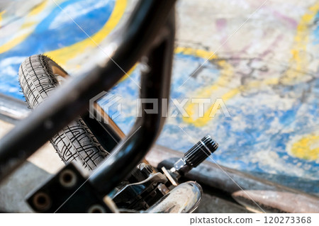 Close up of bmx bike on a ramp in a skatepark Close up of bmx bike on a ramp in a skatepark 120273368