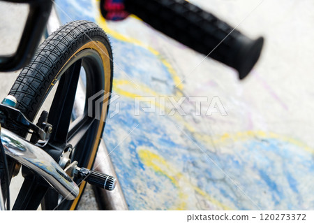 Close up of bmx bike on a ramp in a skatepark Close up of bmx bike on a ramp in a skatepark 120273372