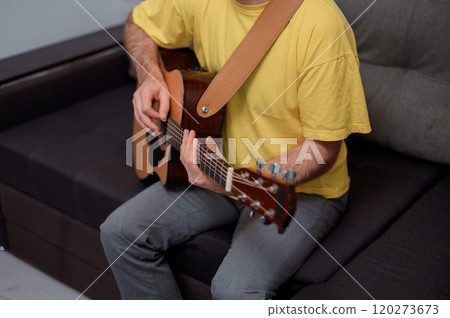 Guitarist on acoustic guitar playing melody in studio. Close up musician instrument Guitarist on acoustic guitar playing melody in studio. Close up musician instrument 120273673