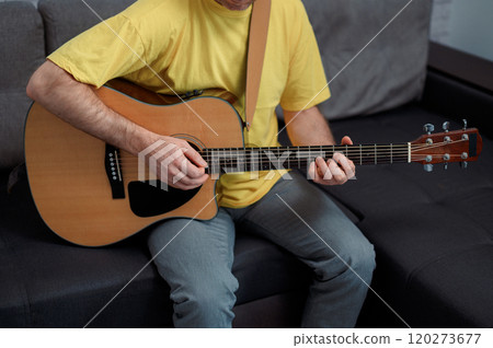 Guitarist on acoustic guitar playing melody in studio. Close up musician instrument 120273677