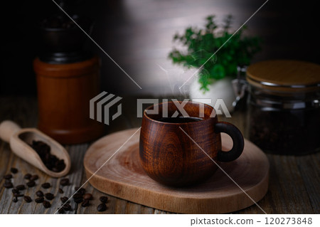 Enjoying coffee in a wooden mug Enjoying coffee in a wooden mug 120273848