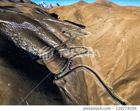 Scenic view of the winding hill road named Pan Long Ancient Road in Tashkurgan, Xinjiang, China. 120274294