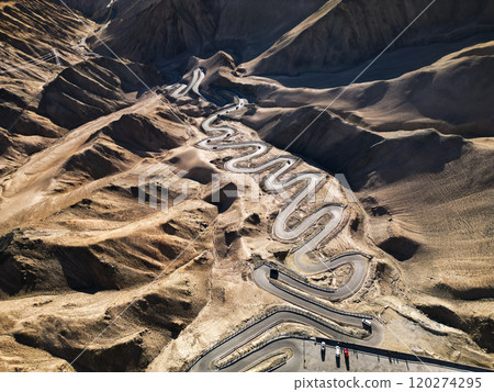 Scenic view of the winding hill road named Pan Long Ancient Road in Tashkurgan, Xinjiang, China. 120274295