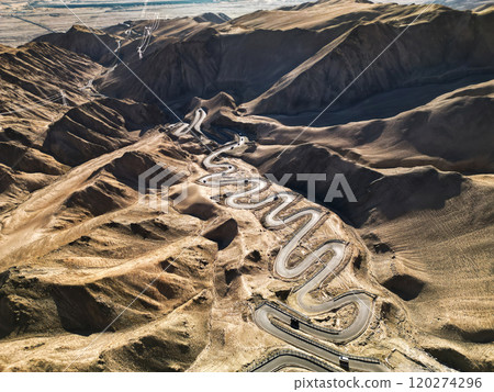 Scenic view of the winding hill road named Pan Long Ancient Road in Tashkurgan, Xinjiang, China. 120274296