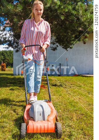 Woman mowing green grass Woman mowing green grass 120274759