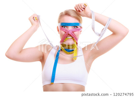 Obsessed fitness woman with a lot of colorful measure tapes 120274795