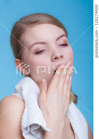 Bored sleepy woman yawning while holding towel Bored sleepy woman yawning while holding towel 120274888