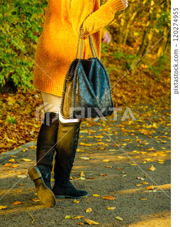Woman wearing orange autumn cardigan outdoor Woman wearing orange autumn cardigan outdoor 120274955