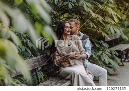 Happy loving couple enjoying their time together in park. Loving couple spending time together. Girl with tattoos. Tattooed woman. Beautiful fashionable couple of lovers on the street. Happy loving couple enjoying their time together in park. Loving couple spending time together. Girl with tattoos. Tattooed woman. Beautiful fashionable couple of lovers on the street. 120275165