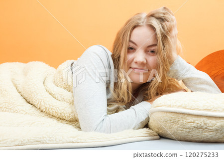 Woman waking up in bed in morning after sleeping Woman waking up in bed in morning after sleeping 120275233