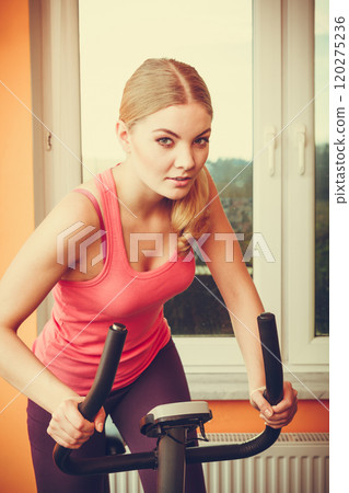 Human working out on exercise bike. Fitness. 120275236