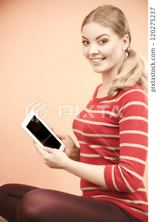 Young woman girl with tablet browsing internet. 120275237