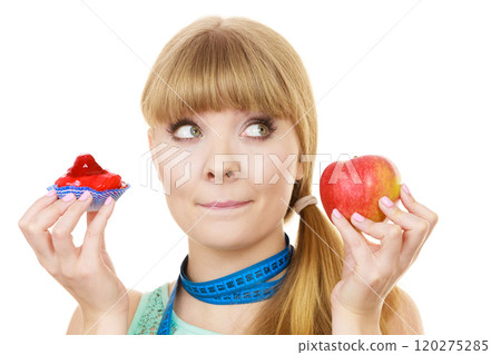 Woman choosing fruit or cake make dietary choice Woman choosing fruit or cake make dietary choice 120275285