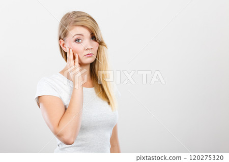 Sad cute young blonde attractive woman 120275320
