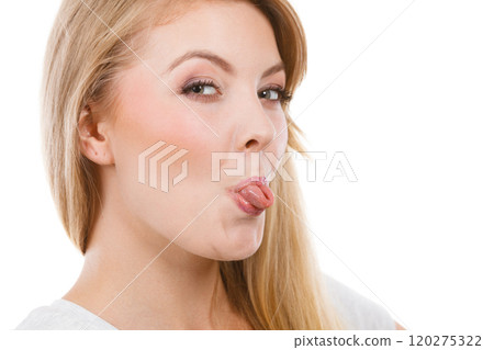 Funny blonde woman sitcking tongue out Funny blonde woman sitcking tongue out 120275322