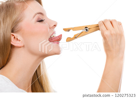 Blonde woman having tongue in clothespin 120275323