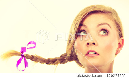 Teenage girl in braid hair making thinking face 120275331