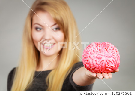 Woman holding brain having idea Woman holding brain having idea 120275501