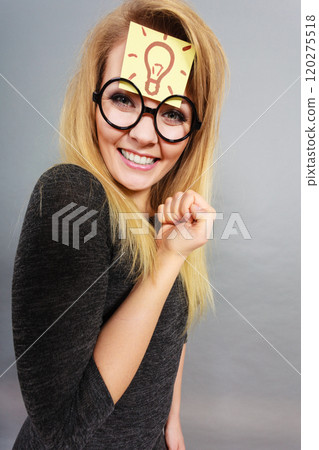 Woman having light bulb mark on forehead thinking Woman having light bulb mark on forehead thinking 120275518