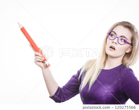Serious woman holds big pencil in hand 120275566