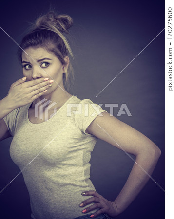 Woman covering her mouth with hand Woman covering her mouth with hand 120275600