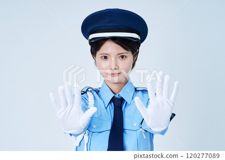 A female security guard making a pose to stop A female security guard making a pose to stop 120277089