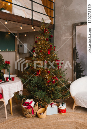 Christmas tree with red ornaments and presents in a living room 120278189