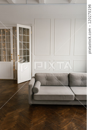 Gray couch in front of a white door in living room Gray couch in front of a white door in living room 120278196
