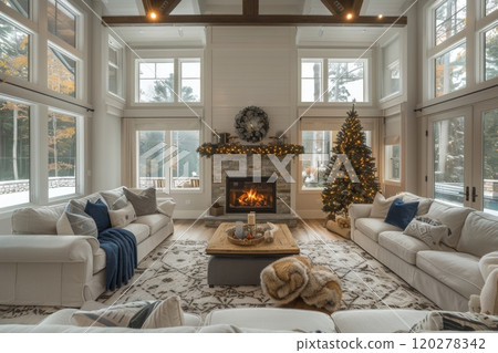 Cozy living room with fireplace and Christmas tree. Home is filled with white furniture and warm and inviting atmosphere 120278342