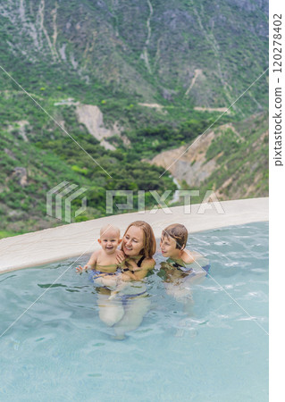Mother with her toddler and teenage sons bathing in the hot springs of Grutas Tolantongo, Mexico. Family adventure, relaxation, and natural wellness concept 120278402