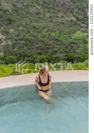 Female tourist at the hot springs of Grutas Tolantongo, Mexico. Adventure, relaxation, and natural wellness concept 120278403