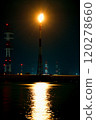 Flare stack reflecting on the water surface 120278660