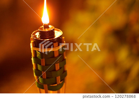 bamboo torches at night with yellow flames and highlights 120278868