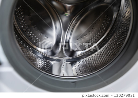 The interior of a modern washing machine drum highlights advanced technology and design The interior of a modern washing machine drum highlights advanced technology and design 120279051