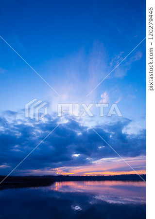 A Serene Sunset Reflection Over Calm and Tranquil Water Creates a Perfect Atmosphere A Serene Sunset Reflection Over Calm and Tranquil Water Creates a Perfect Atmosphere 120279446
