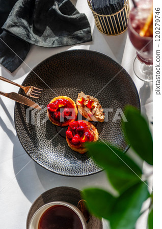 Light breakfast in a restaurant with coffee and pancakes with cherry jam 120279746