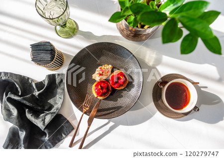 Light breakfast in a restaurant with coffee and pancakes with cherry jam 120279747