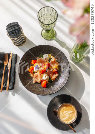 Hearty breakfast in a restaurant with prosciutto, tomatoes and cream cheese 120279749