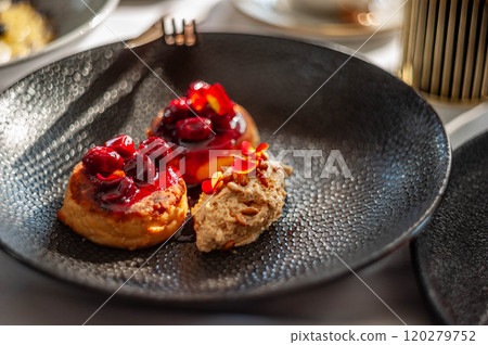 Light breakfast in a restaurant with coffee and pancakes with cherry jam Light breakfast in a restaurant with coffee and pancakes with cherry jam 120279752