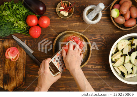 Preparing fresh ingredients for a vibrant dish on a wooden kitchen counter in a cozy home 120280809