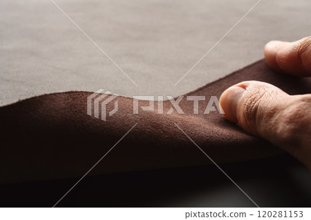 Closeup man hand check dark brown full grain leather Closeup man hand check dark brown full grain leather 120281153