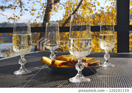 Bridal Shower. Four glasses of champagne with pineapples in nature 120281159