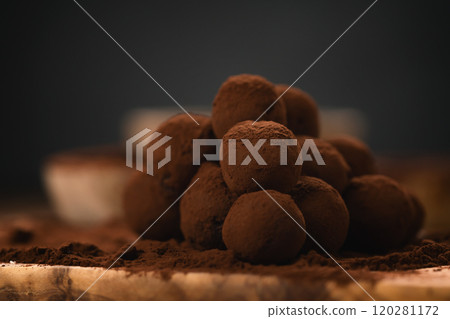 craft chocolate truffles on wooden board with cocoa powder 120281172