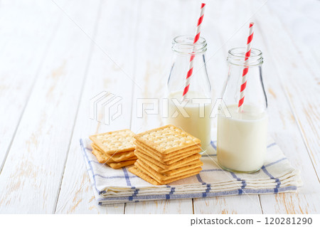 Wheat biscuits and bottles of fresh milk on a light kitchen table,healthy breakfast. 120281290