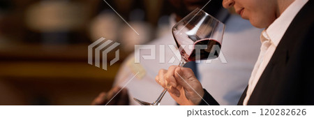 Website banner with unrecognizable woman holding polished crystal glass with red wine and smelling scent Website banner with unrecognizable woman holding polished crystal glass with red wine and smelling scent 120282626