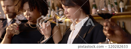 Website banner of biracial professional sommeliers estimating perfect scent of dry wine 120282633