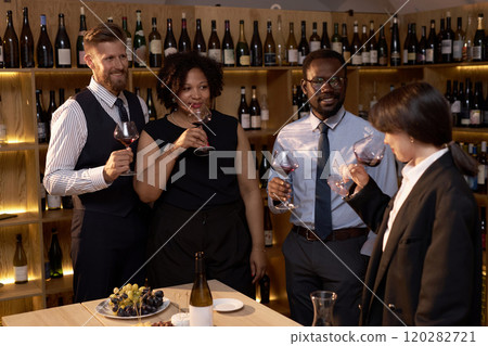 High angle shot of multiracial group of professional sommeliers exepertizing brand new wine during special degustation 120282721