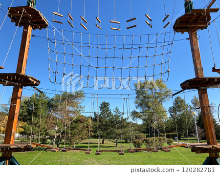 Rope adventure park for active recreation of adults and children Rope adventure park for active recreation of adults and children 120282781