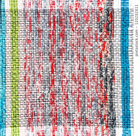 Old handmade homespun doormat from strips of cloth. Texture of a homemade rug 120282811