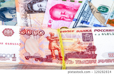 Five thousandths banknotes of russian rubles against the background of money of various states Five thousandths banknotes of russian rubles against the background of money of various states 120282814
